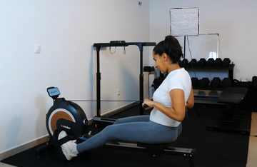 Person enjoying a low-impact, full-body workout on the Wenoker Rowing Machine at home.