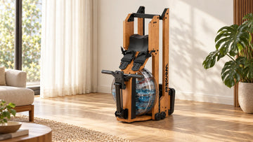 The Wenoker RW10 Pro solid wood water rowing machine stored vertically against a neutral living room wall beside an indoor plant.